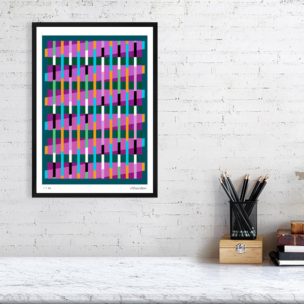 Colourful Lux Series abstract print by Victoria Mardon on a white brick wall, styled with creative studio supplies below.
