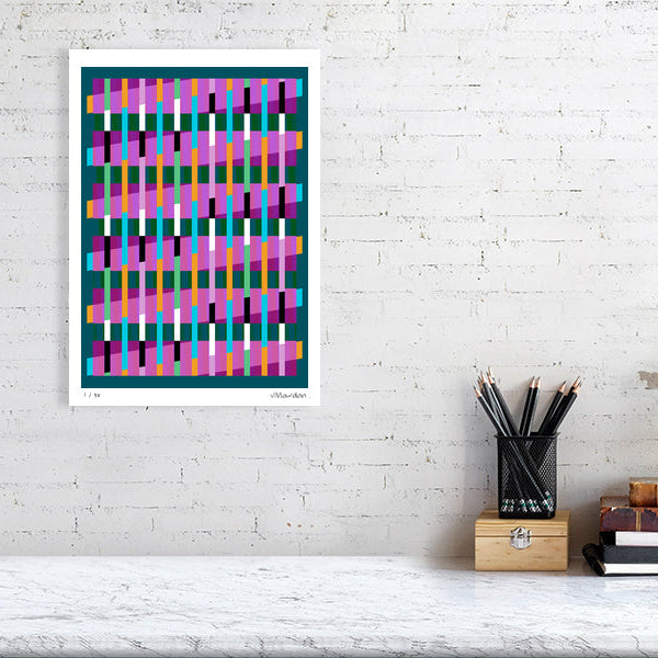 Colourful Lux Series abstract print by Victoria Mardon on a white brick wall, styled with creative studio supplies below.