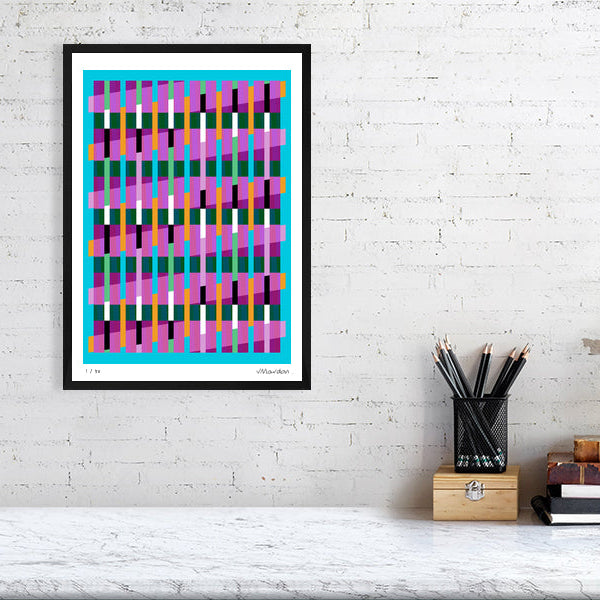 Colourful Lux Series abstract print by Victoria Mardon on a white brick wall, styled with creative studio supplies below.