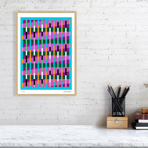 Colourful Lux Series abstract print by Victoria Mardon on a white brick wall, styled with creative studio supplies below.