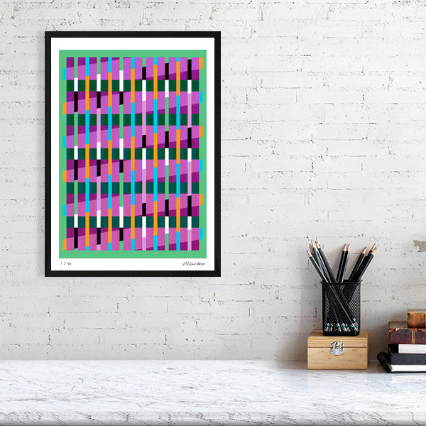 Colourful Lux Series abstract print by Victoria Mardon on a white brick wall, styled with creative studio supplies below.
