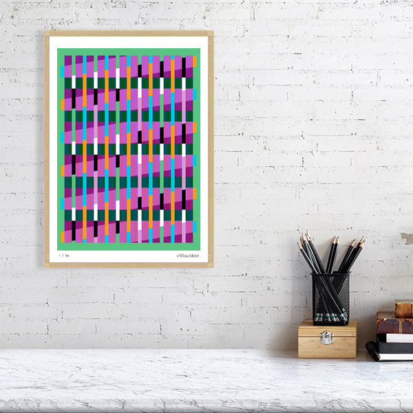 Colourful Lux Series abstract print by Victoria Mardon on a white brick wall, styled with creative studio supplies below.