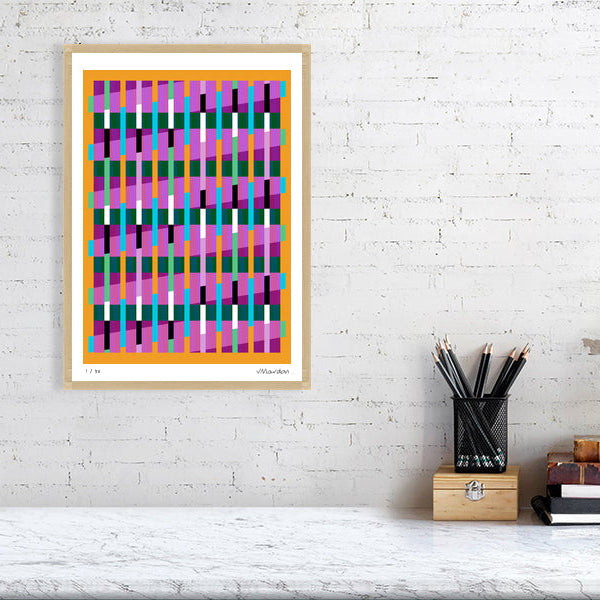 Colourful Lux Series abstract print by Victoria Mardon on a white brick wall, styled with creative studio supplies below.