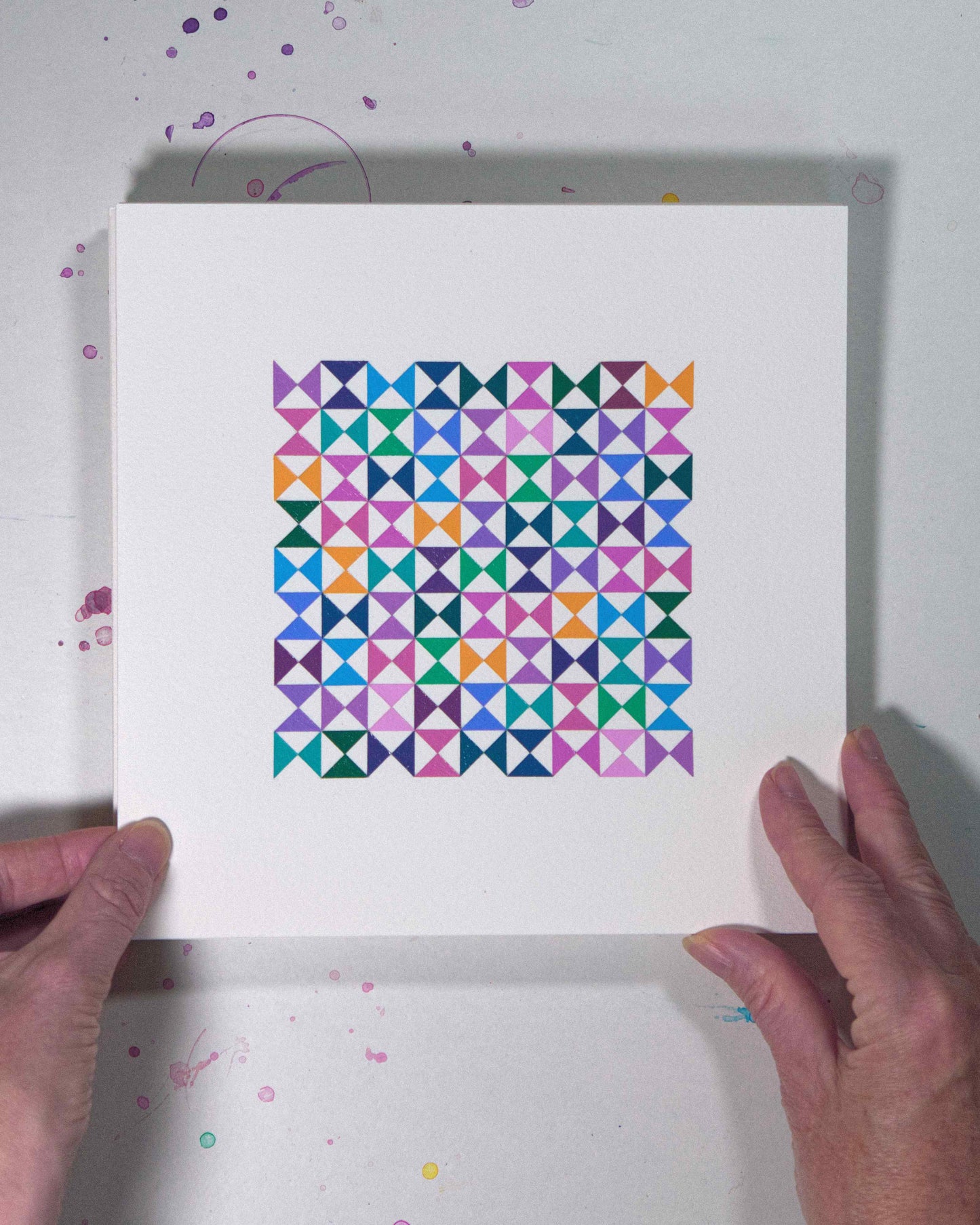 Hands holding a bold, graphic multicoloured abstract painting with repeating geometric shapes, 5 August – 036/365 (46239/365) by Victoria Mardon, 365: A Year in Colour series.