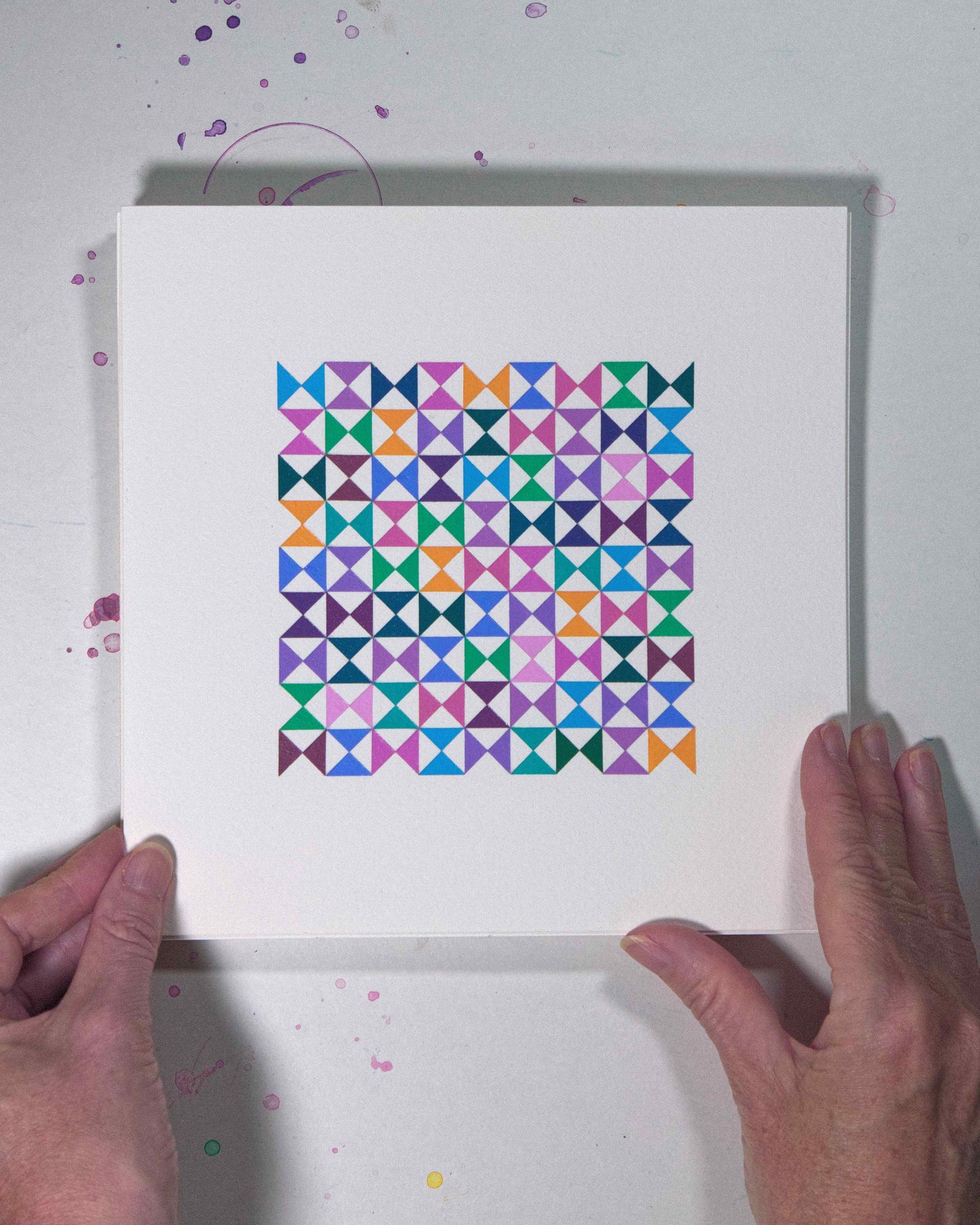 Hands holding a bold, graphic multicoloured abstract painting with repeating geometric shapes, 16 August – 047/365 (46250/365) by Victoria Mardon, 365: A Year in Colour series.
