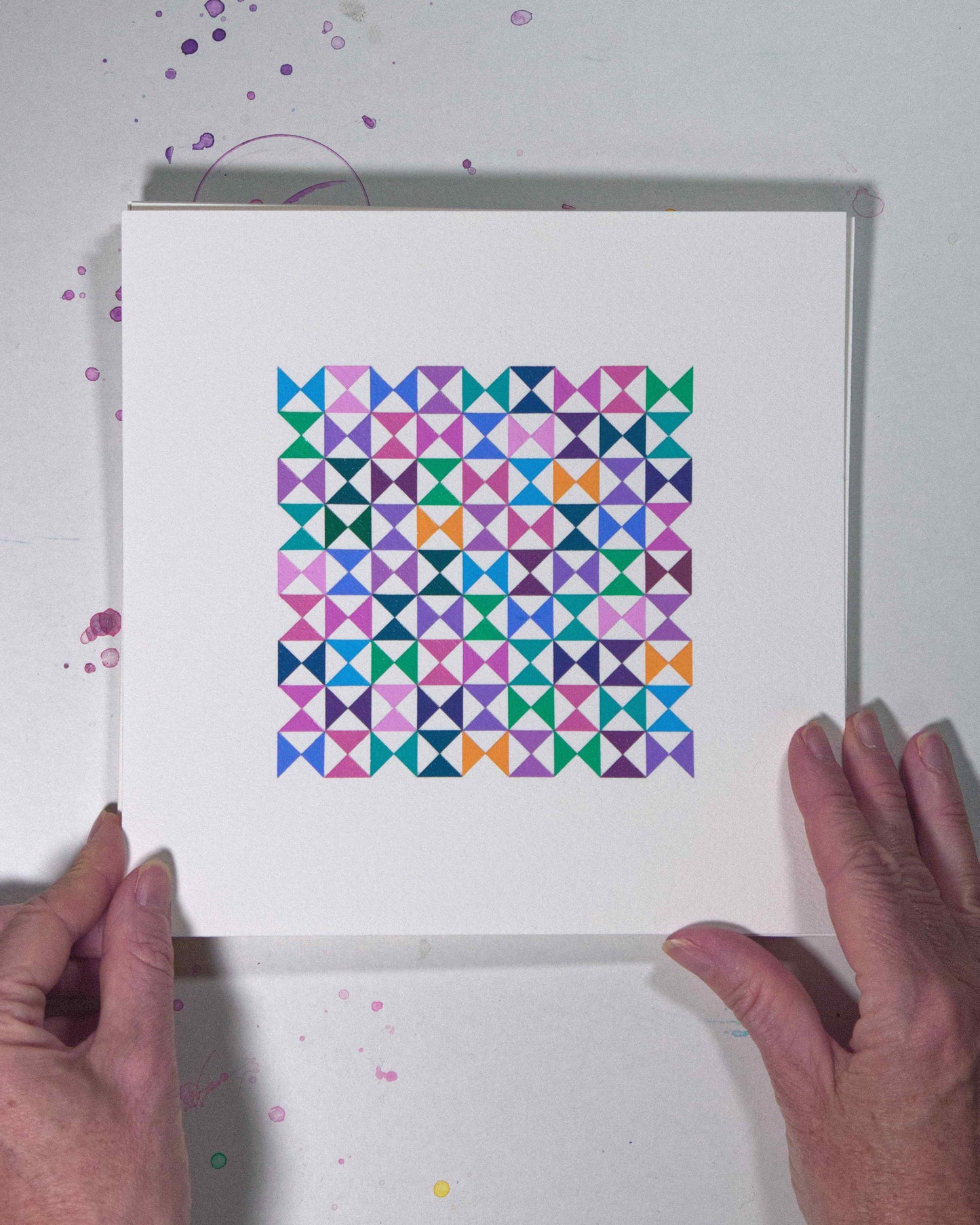 Hands holding a bold, graphic multicoloured abstract painting with repeating geometric shapes, 19 August – 050/365 (46253/365) by Victoria Mardon, 365: A Year in Colour series.