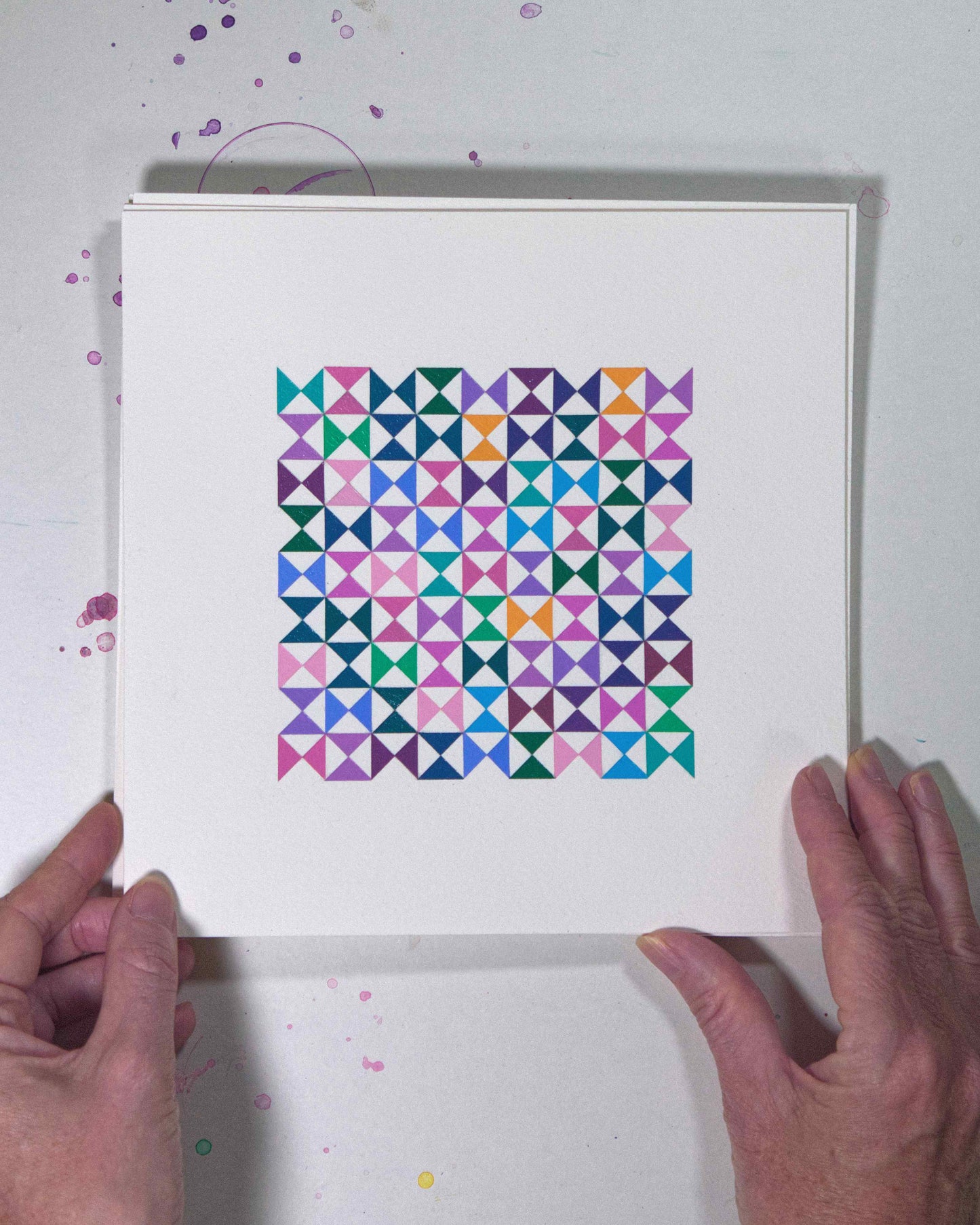 Hands holding a bold, graphic multicoloured abstract painting with repeating geometric shapes, 20 July – 020/365 (46223/365) by Victoria Mardon, 365: A Year in Colour series.