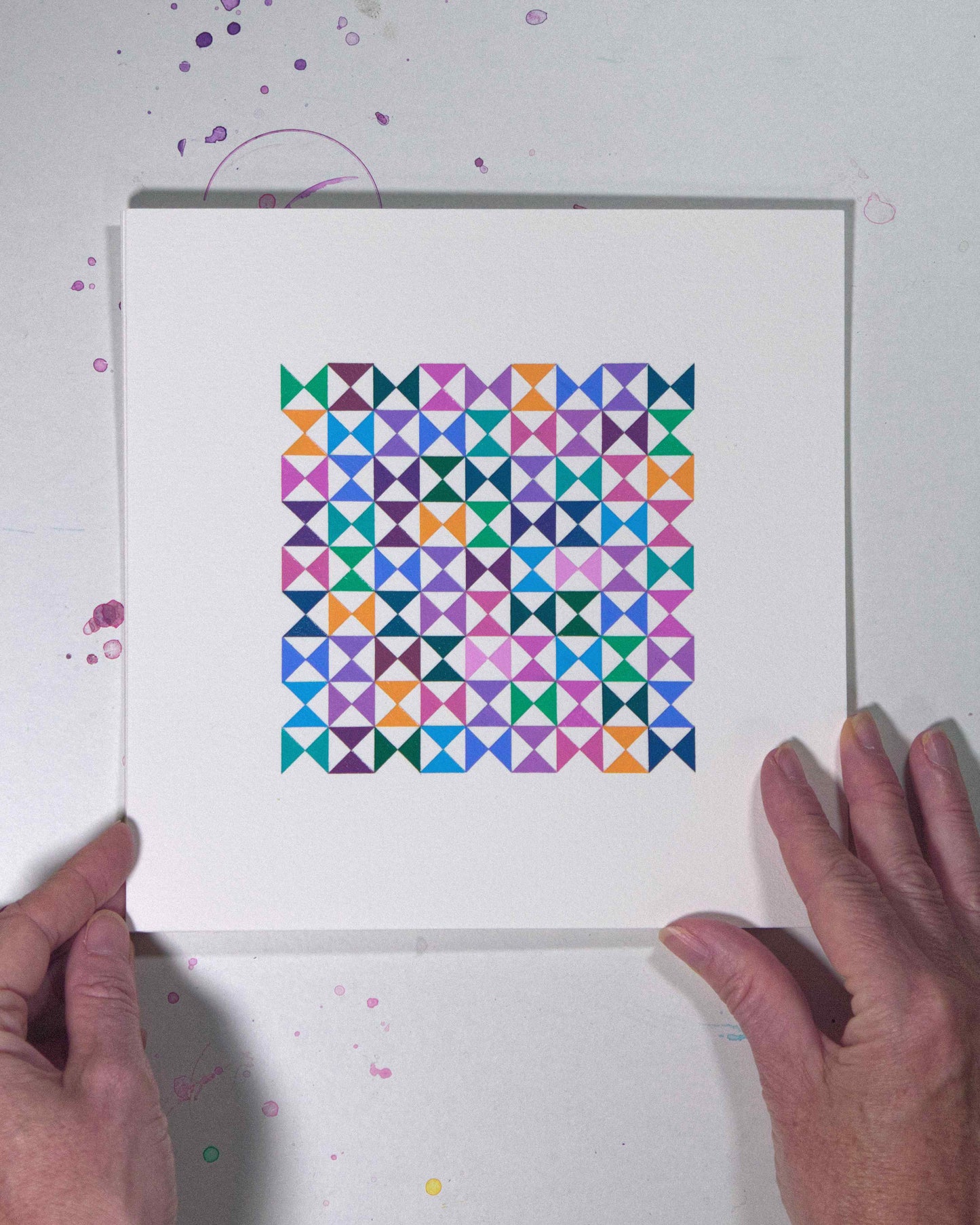Hands holding a bold, graphic multicoloured abstract painting with repeating geometric shapes, 27 August – 058/365 (46261/365) by Victoria Mardon, 365: A Year in Colour series.