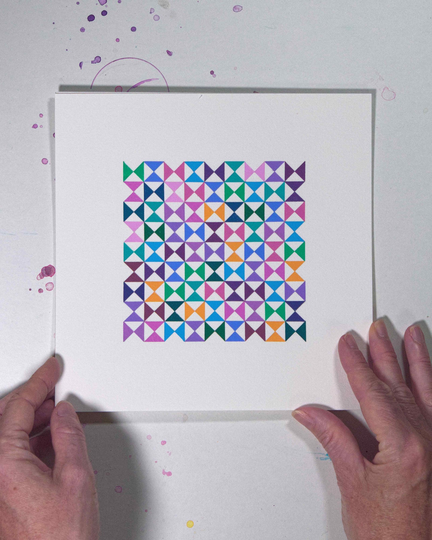 Hands holding a bold, graphic multicoloured abstract painting with repeating geometric shapes, 28 August – 059/365 (46262/365) by Victoria Mardon, 365: A Year in Colour series.