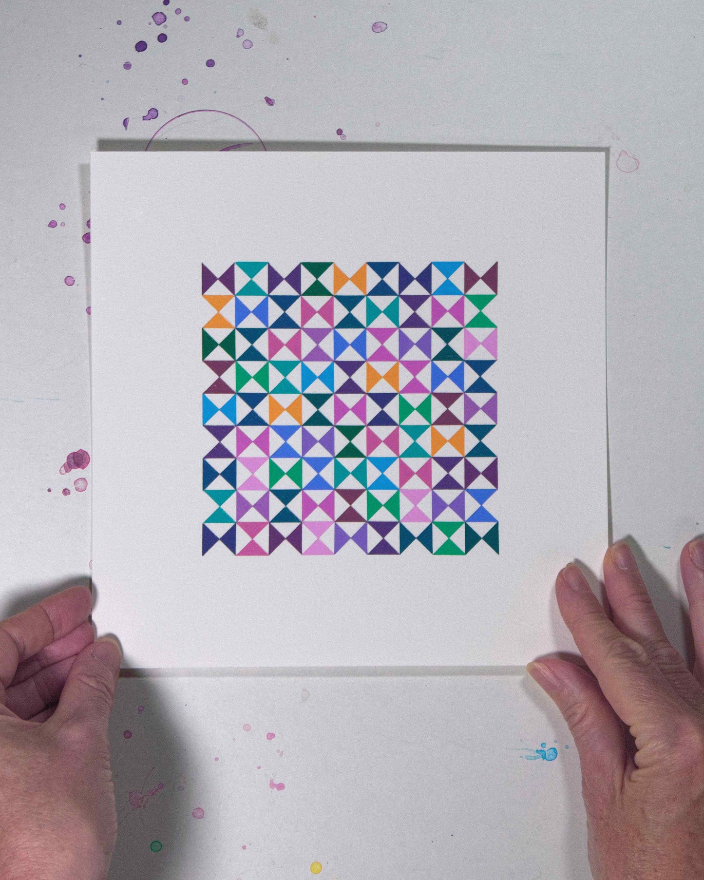 Hands holding a bold, graphic multicoloured abstract painting with repeating geometric shapes, 31 August – 062/365 (46265/365) by Victoria Mardon, 365: A Year in Colour series.