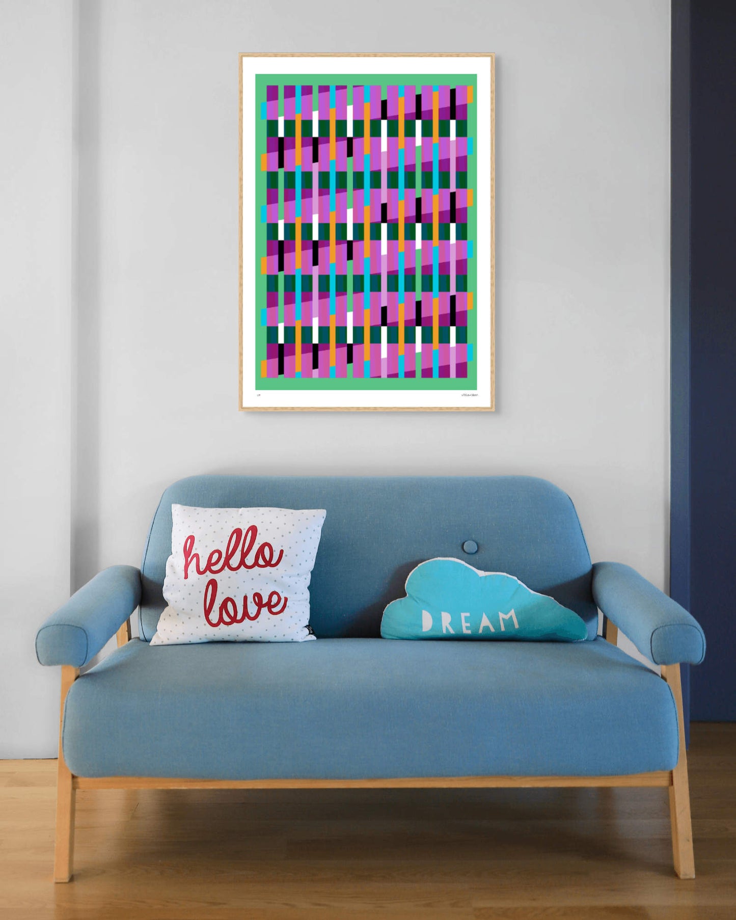 Green geometric abstract giclée print by Victoria Mardon in an oak frame displayed above a blue mid-century sofa