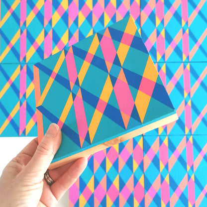 “I PG7/PB15:3 – PB15:3/PG7” – one module from Victoria Mardon’s B.E.L.O.N.G.I.N.G series held in front of the full artwork. Colourful geometric pattern on canvas, shown in context.