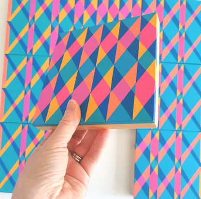 “N2 PG7/PB15:3 – PB15:3/PG7” – one module from Victoria Mardon’s B.E.L.O.N.G.I.N.G series held in front of the full artwork. Colourful geometric pattern on canvas, shown in context.