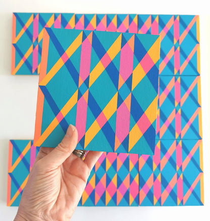 “O PG7/PB15:3 – PB15:3/PG7”– one module from Victoria Mardon’s B.E.L.O.N.G.I.N.G series held in front of the full artwork. Colourful geometric pattern on canvas, shown in context.