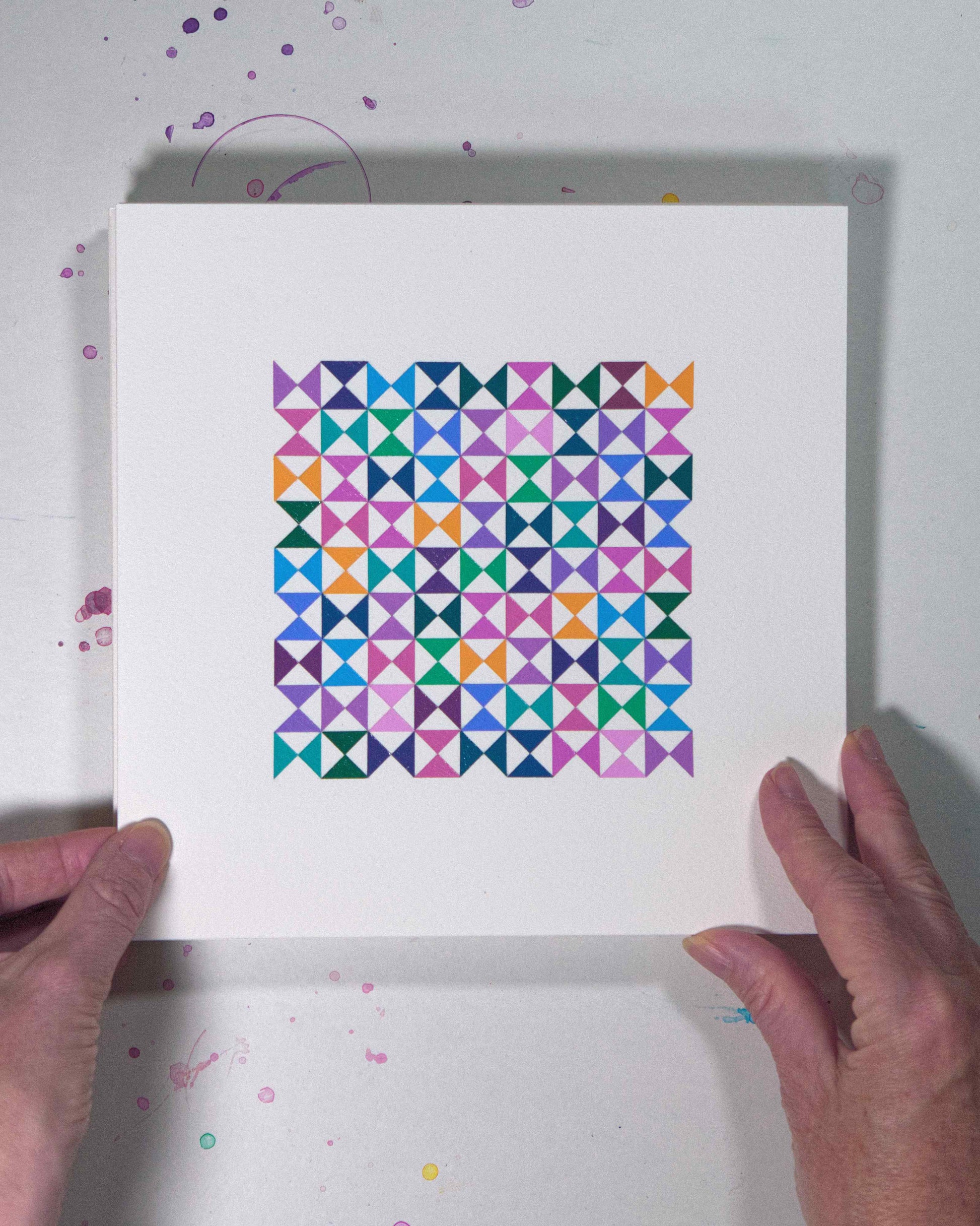 Hands holding a bold, graphic multicoloured abstract painting with repeating geometric shapes, 5 August – 036/365 (46239/365) by Victoria Mardon, 365: A Year in Colour series.