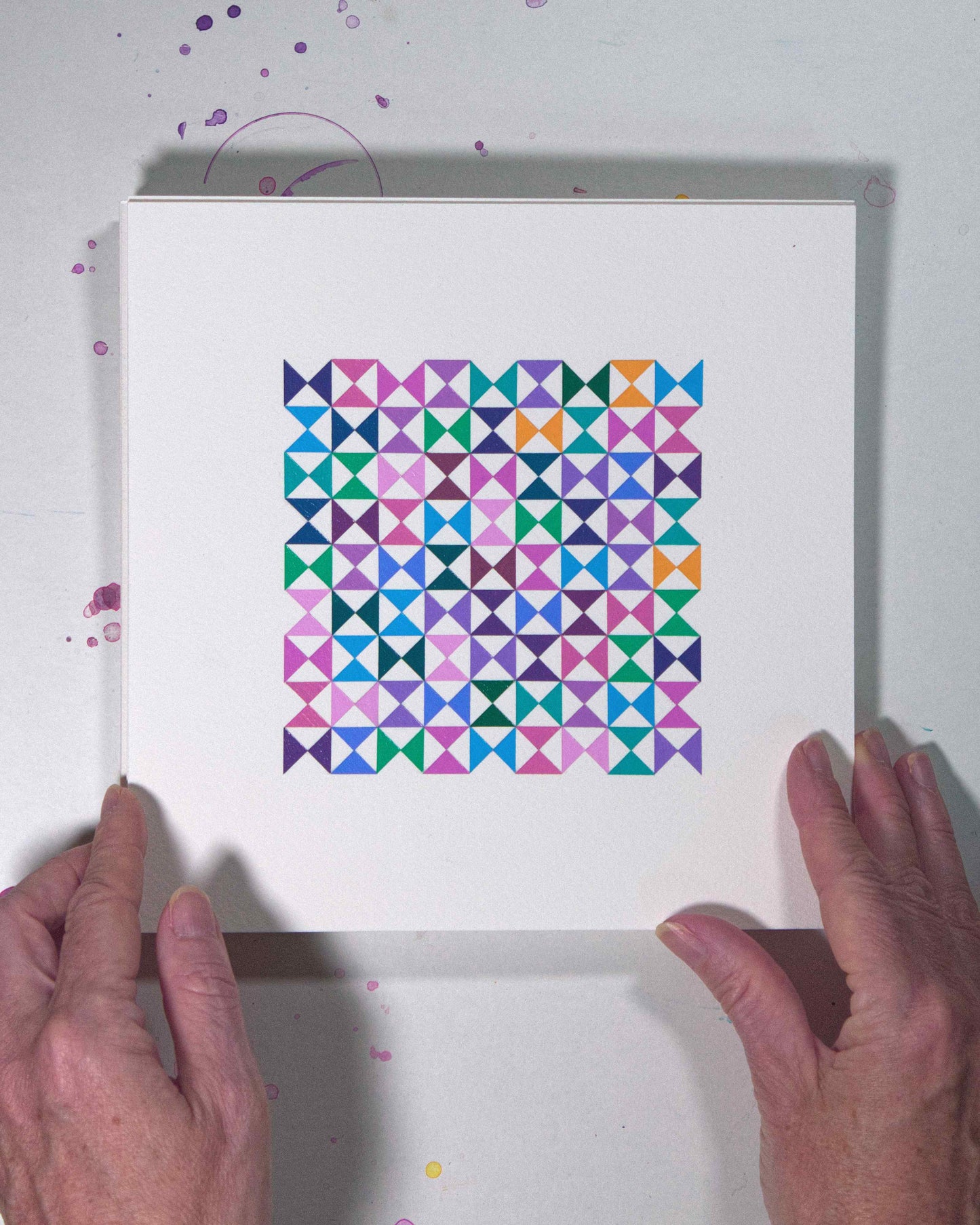 Hands holding a bold, graphic multicoloured abstract painting with repeating geometric shapes, 9 August – 040/365 (46243/365) by Victoria Mardon, 365: A Year in Colour series.
