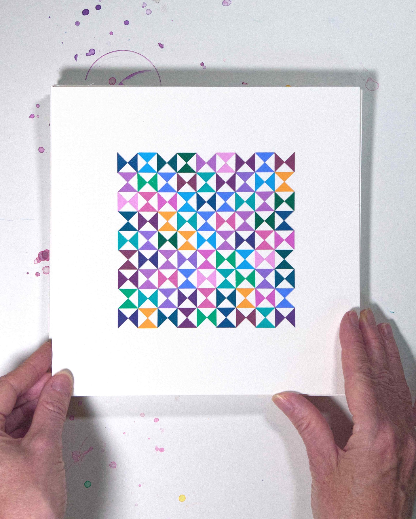 Hands holding a bold, graphic multicoloured abstract painting with repeating geometric shapes, 11 August – 042/365 (46245/365) by Victoria Mardon, 365: A Year in Colour series.
