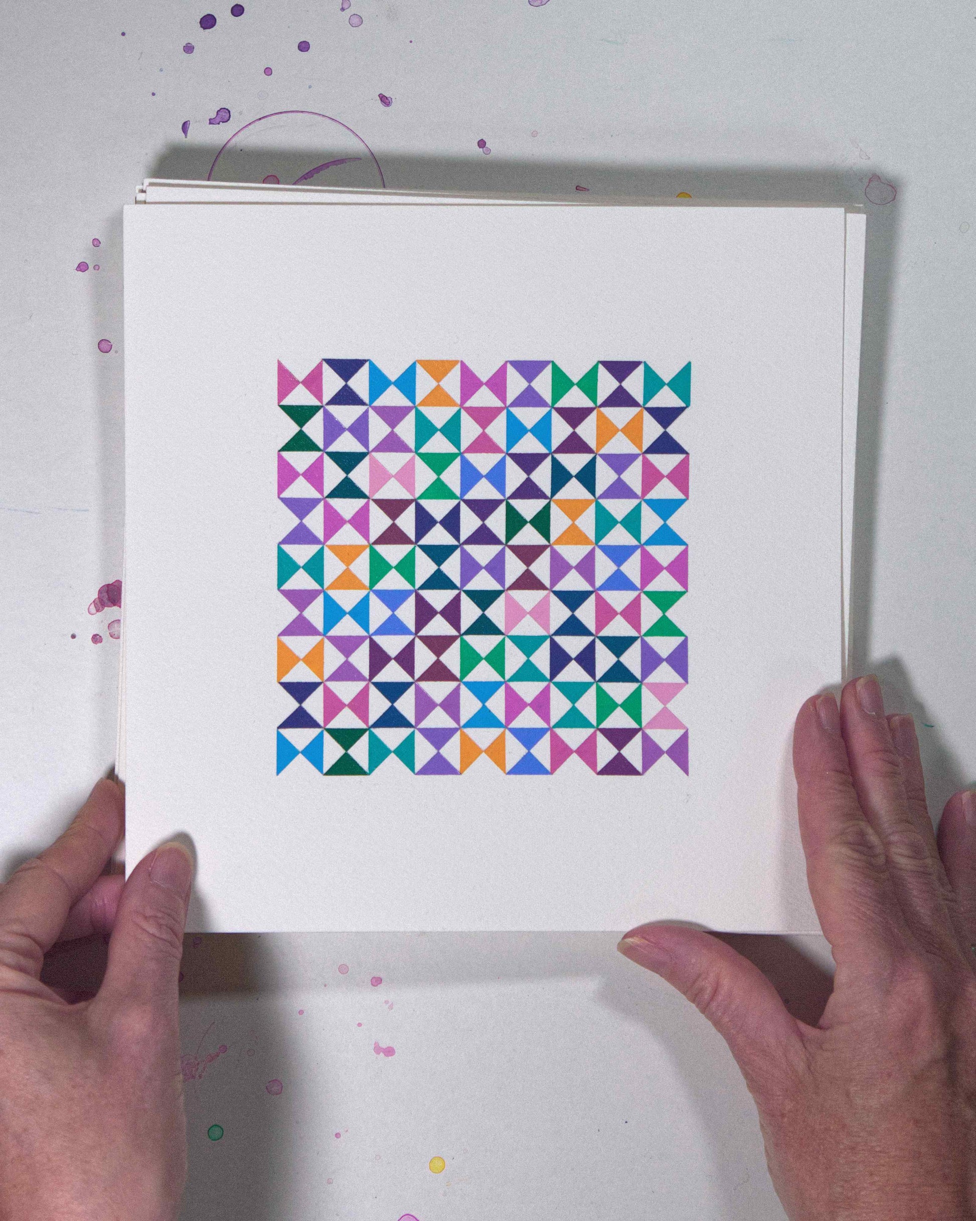 Hands holding a bold, graphic multicoloured abstract painting with repeating geometric shapes, 11 July – 011/365 (46214/365) by Victoria Mardon, 365: A Year in Colour series.