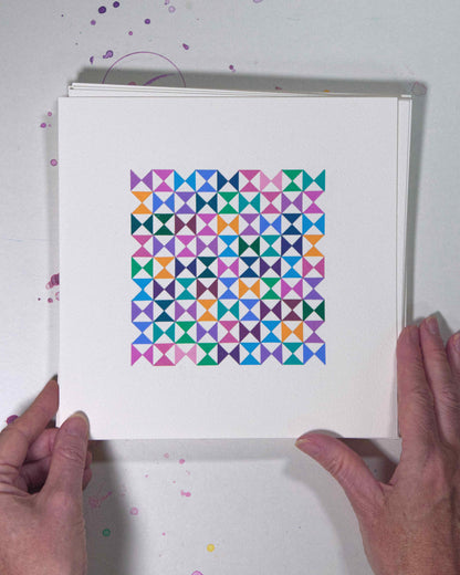 Hands holding a bold, graphic multicoloured abstract painting with repeating geometric shapes, 12 July – 012/365 (46215/365) by Victoria Mardon, 365: A Year in Colour series.