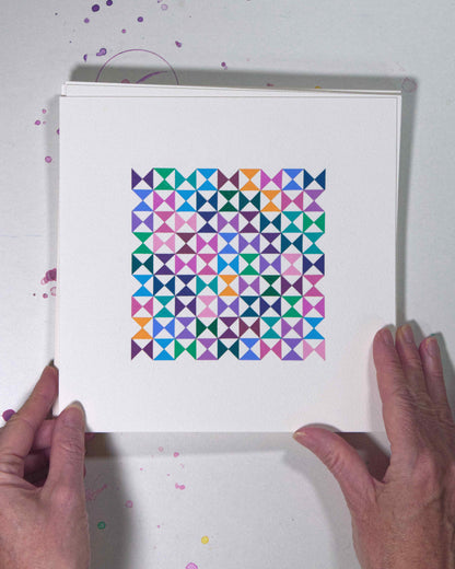 Hands holding a bold, graphic multicoloured abstract painting with repeating geometric shapes, 13 July – 013/365 (46216/365) by Victoria Mardon, 365: A Year in Colour series.