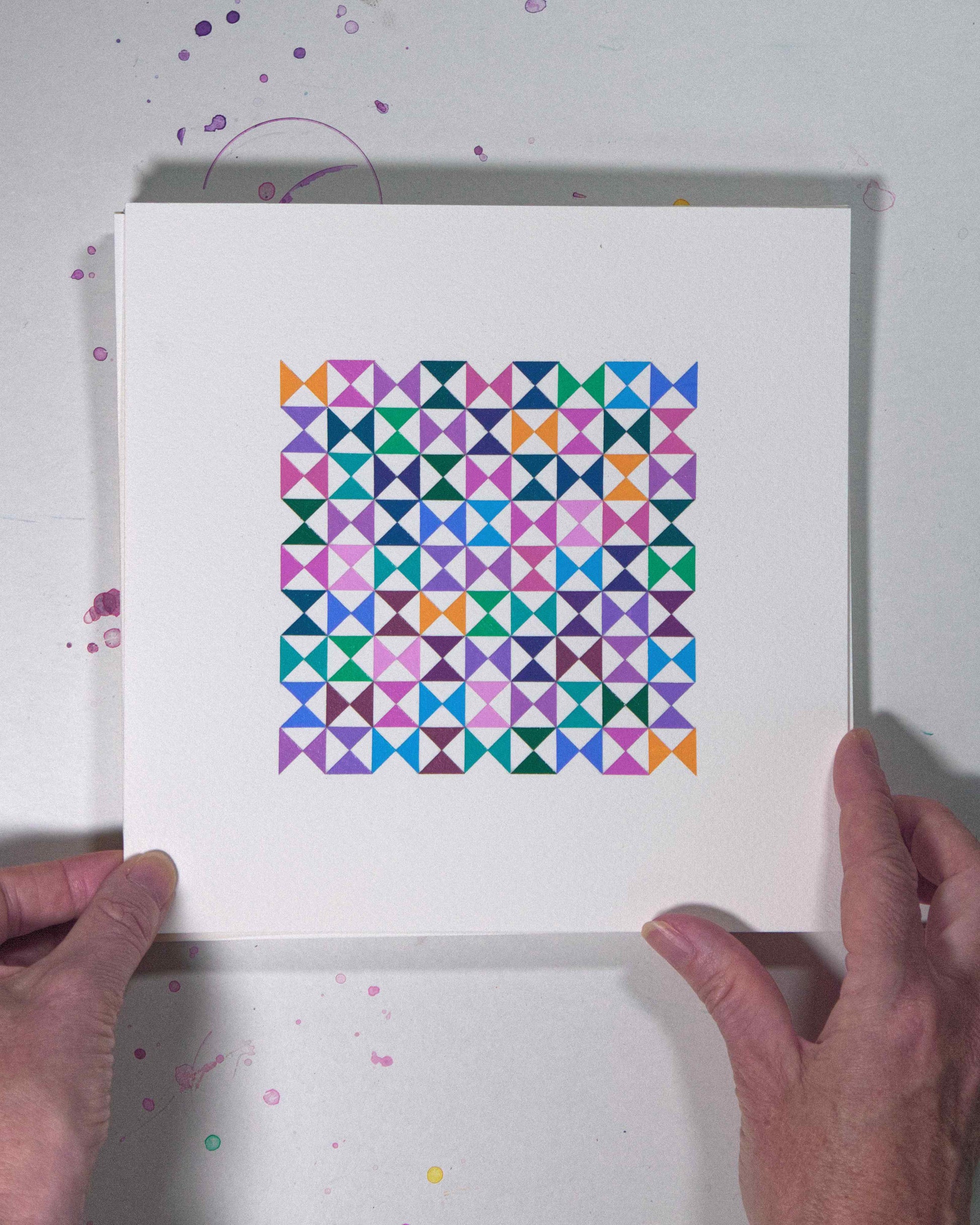 Hands holding a bold, graphic multicoloured abstract painting with repeating geometric shapes, 14 August – 045/365 (46248/365) by Victoria Mardon, 365: A Year in Colour series.