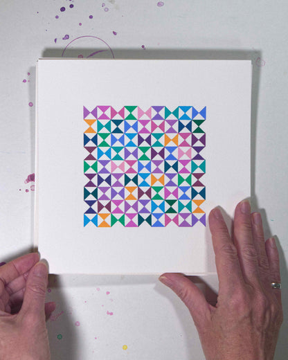 Hands holding a bold, graphic multicoloured abstract painting with repeating geometric shapes, 18 July – 018/365 (46221/365) by Victoria Mardon, 365: A Year in Colour series.