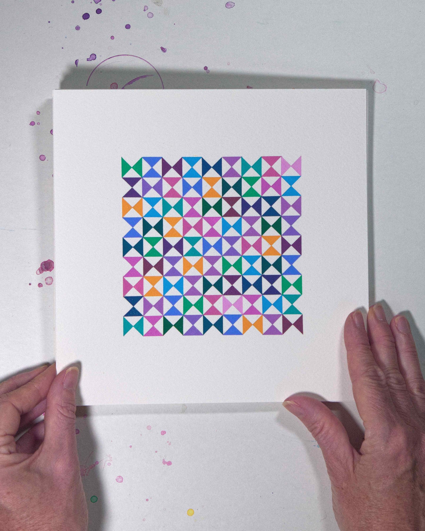 Hands holding a bold, graphic multicoloured abstract painting with repeating geometric shapes, 20 August – 051/365 (46254/365) by Victoria Mardon, 365: A Year in Colour series.