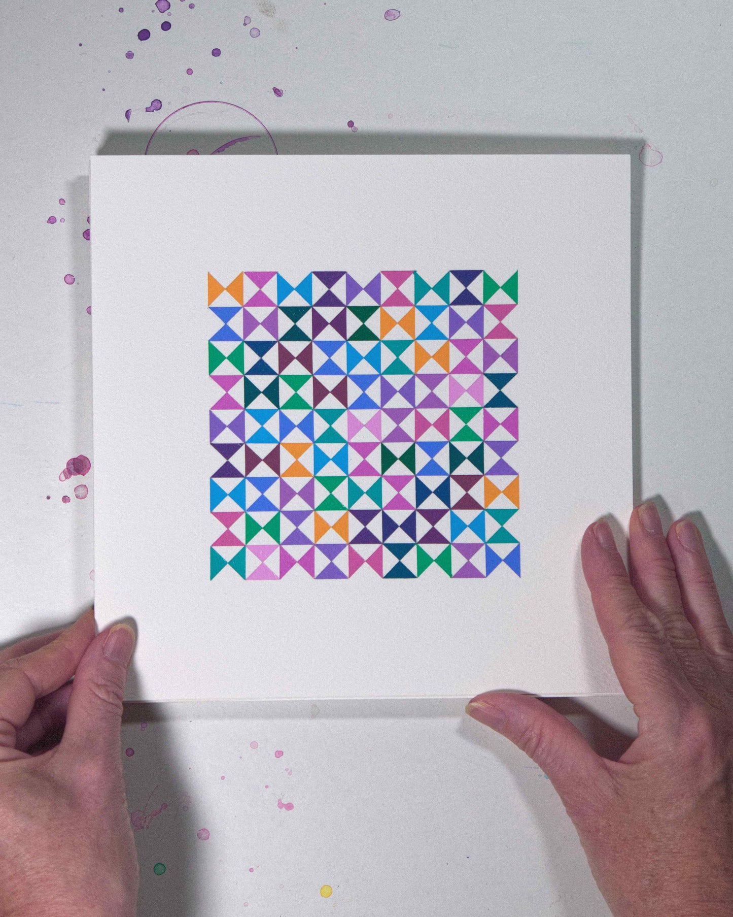 Hands holding a bold, graphic multicoloured abstract painting with repeating geometric shapes, 21 August – 052/365 (46255/365) by Victoria Mardon, 365: A Year in Colour series.
