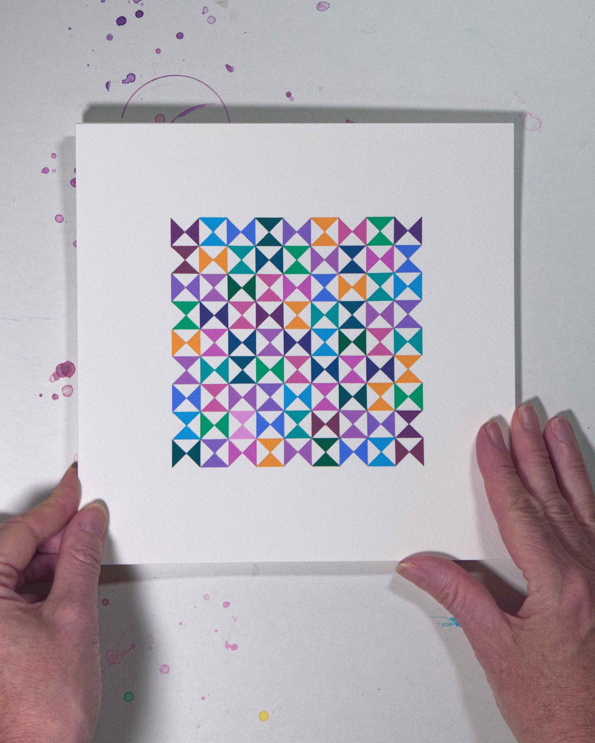 Hands holding a bold, graphic multicoloured abstract painting with repeating geometric shapes, 22 August – 053/365 (46256/365) by Victoria Mardon, 365: A Year in Colour series.