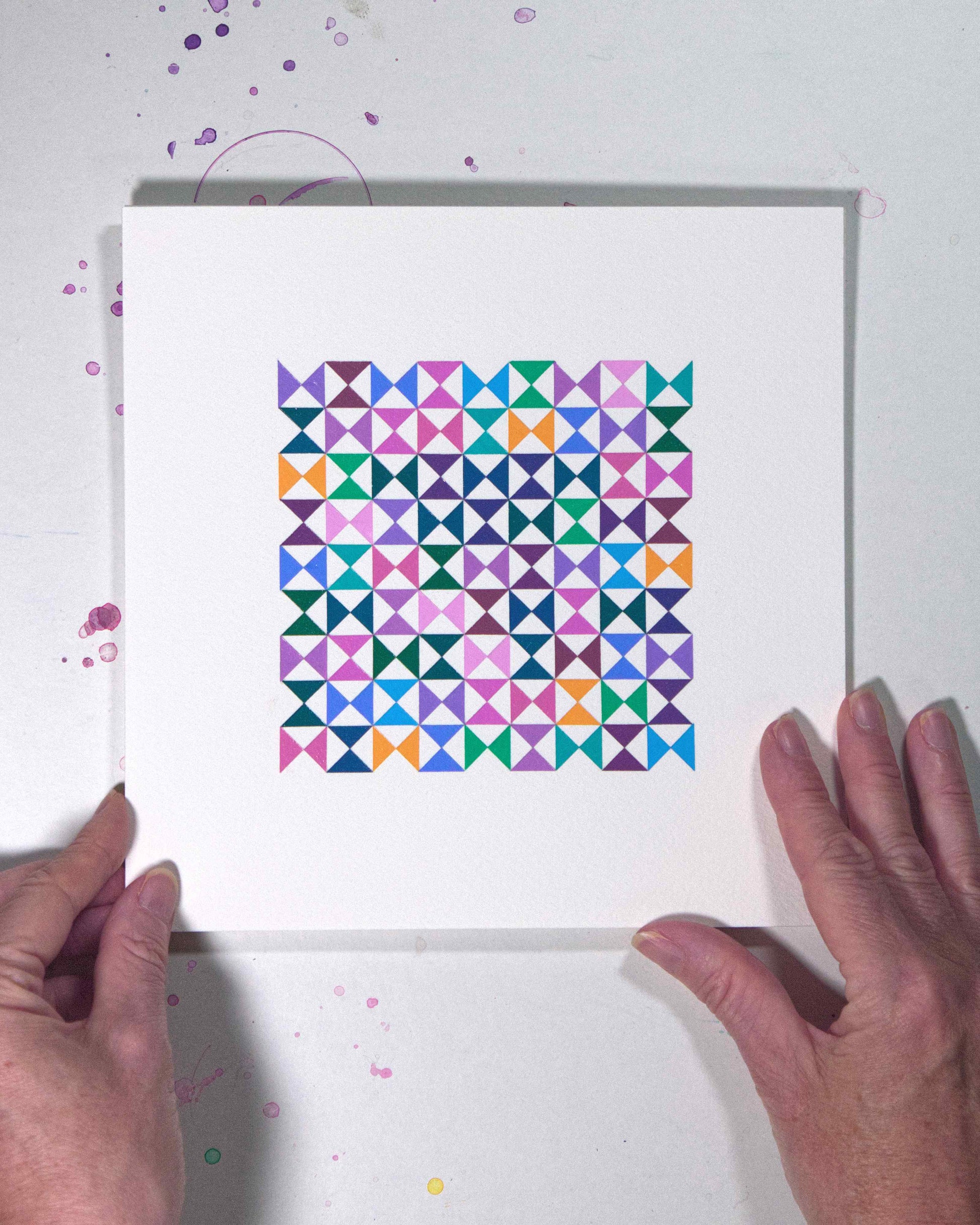 Hands holding a bold, graphic multicoloured abstract painting with repeating geometric shapes, 24 August – 055/365 (46258/365) by Victoria Mardon, 365: A Year in Colour series.