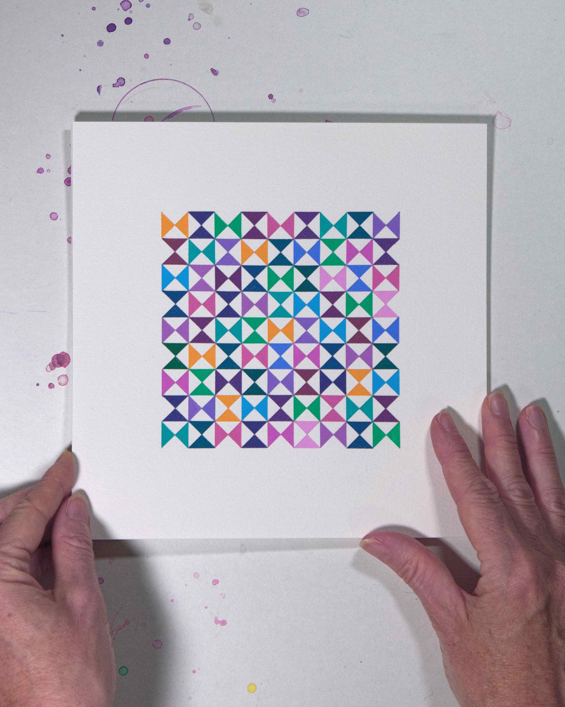 Hands holding a bold, graphic multicoloured abstract painting with repeating geometric shapes, 26 August – 057/365 (46260/365) by Victoria Mardon, 365: A Year in Colour series.