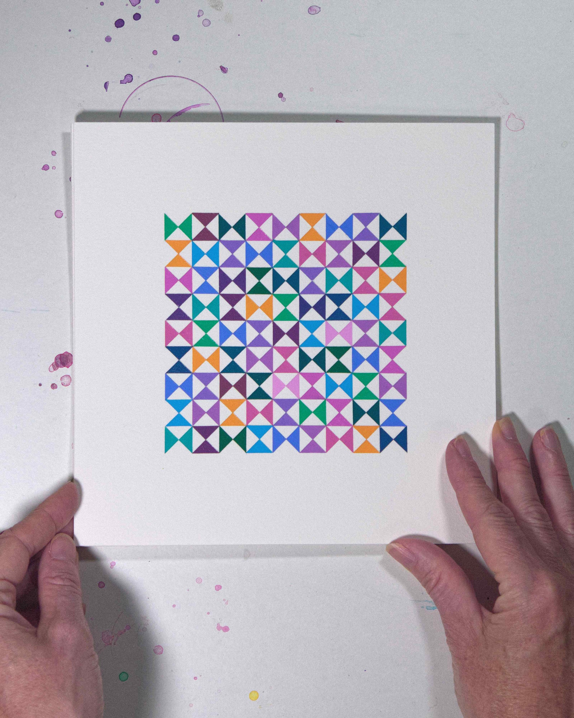 Hands holding a bold, graphic multicoloured abstract painting with repeating geometric shapes, 27 August – 058/365 (46261/365) by Victoria Mardon, 365: A Year in Colour series.