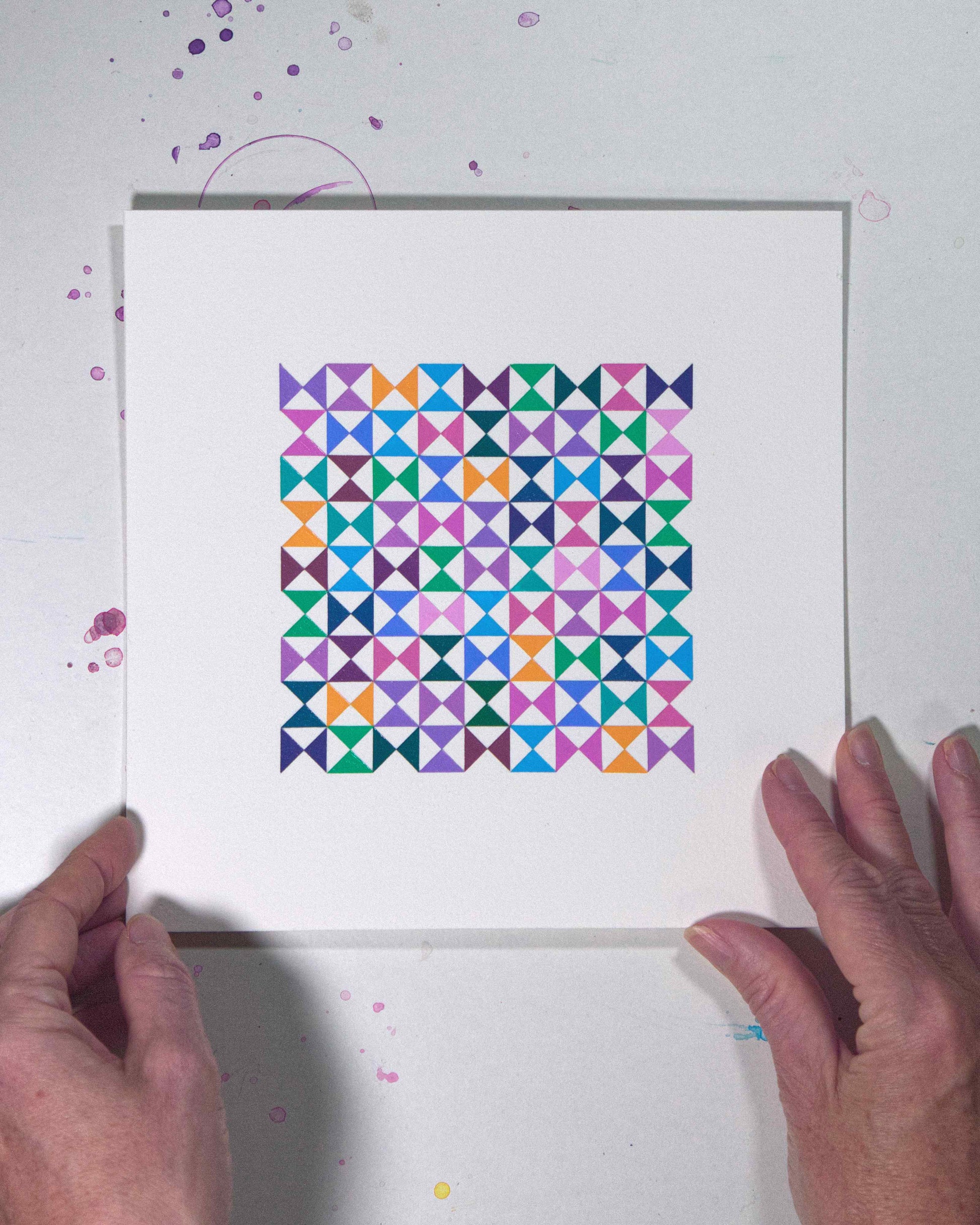 Hands holding a bold, graphic multicoloured abstract painting with repeating geometric shapes, 29 August – 060/365 (46263/365) by Victoria Mardon, 365: A Year in Colour series.