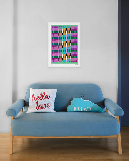 Green geometric abstract giclée print by Victoria Mardon in a white frame displayed above a blue mid-century sofa