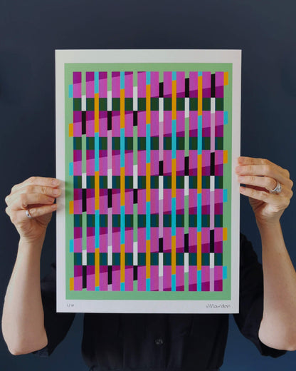 Green geometric abstract giclée print by Victoria Mardon held in hands against a dark background