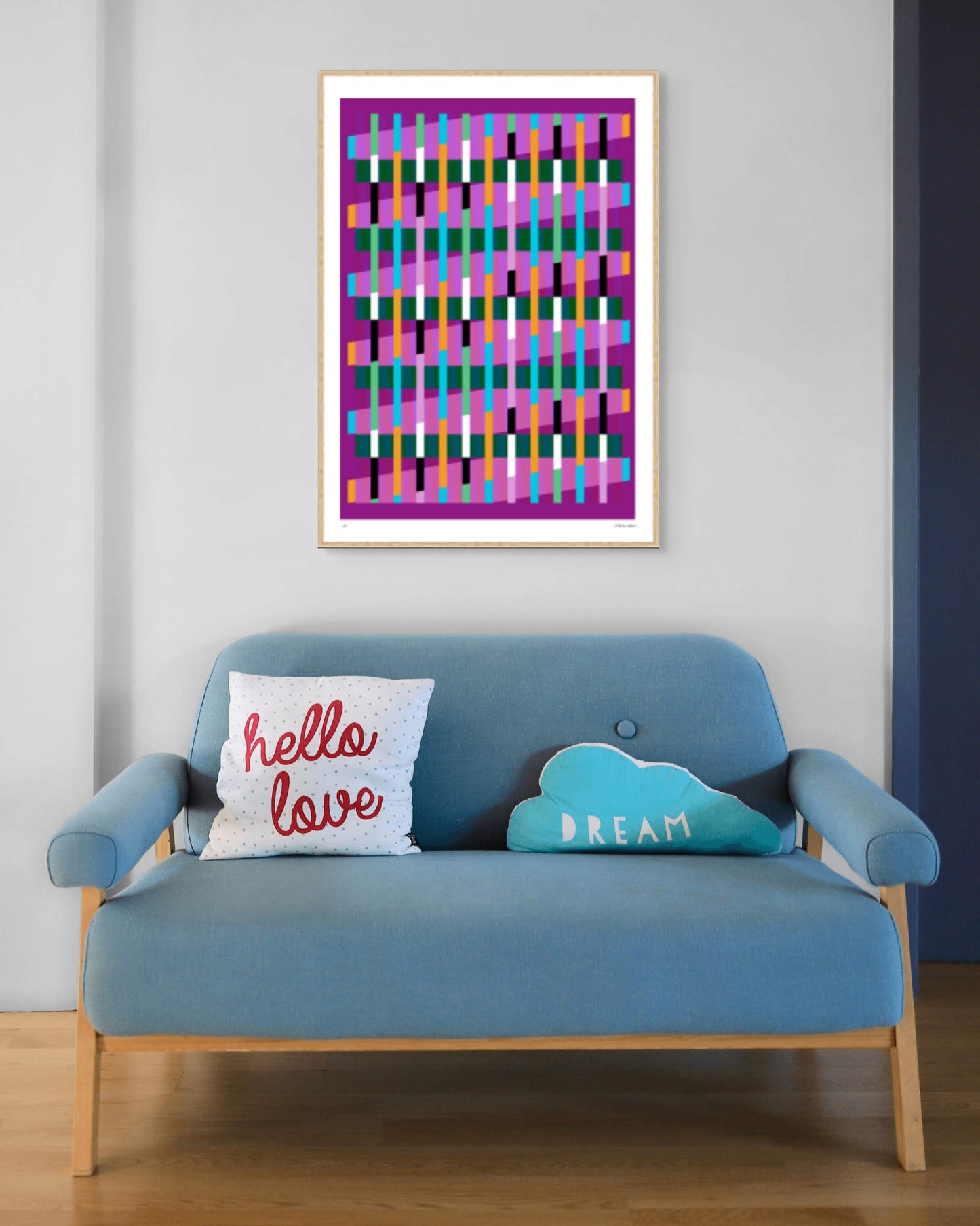 Magenta geometric abstract giclée print by Victoria Mardon in an oak frame displayed above a blue mid-century sofa