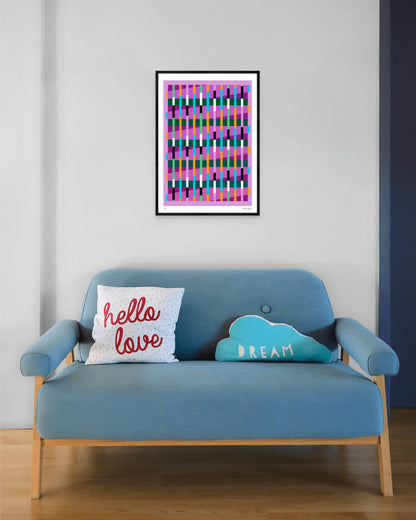Pink geometric abstract giclée print by Victoria Mardon in a black frame displayed above a blue mid-century sofa