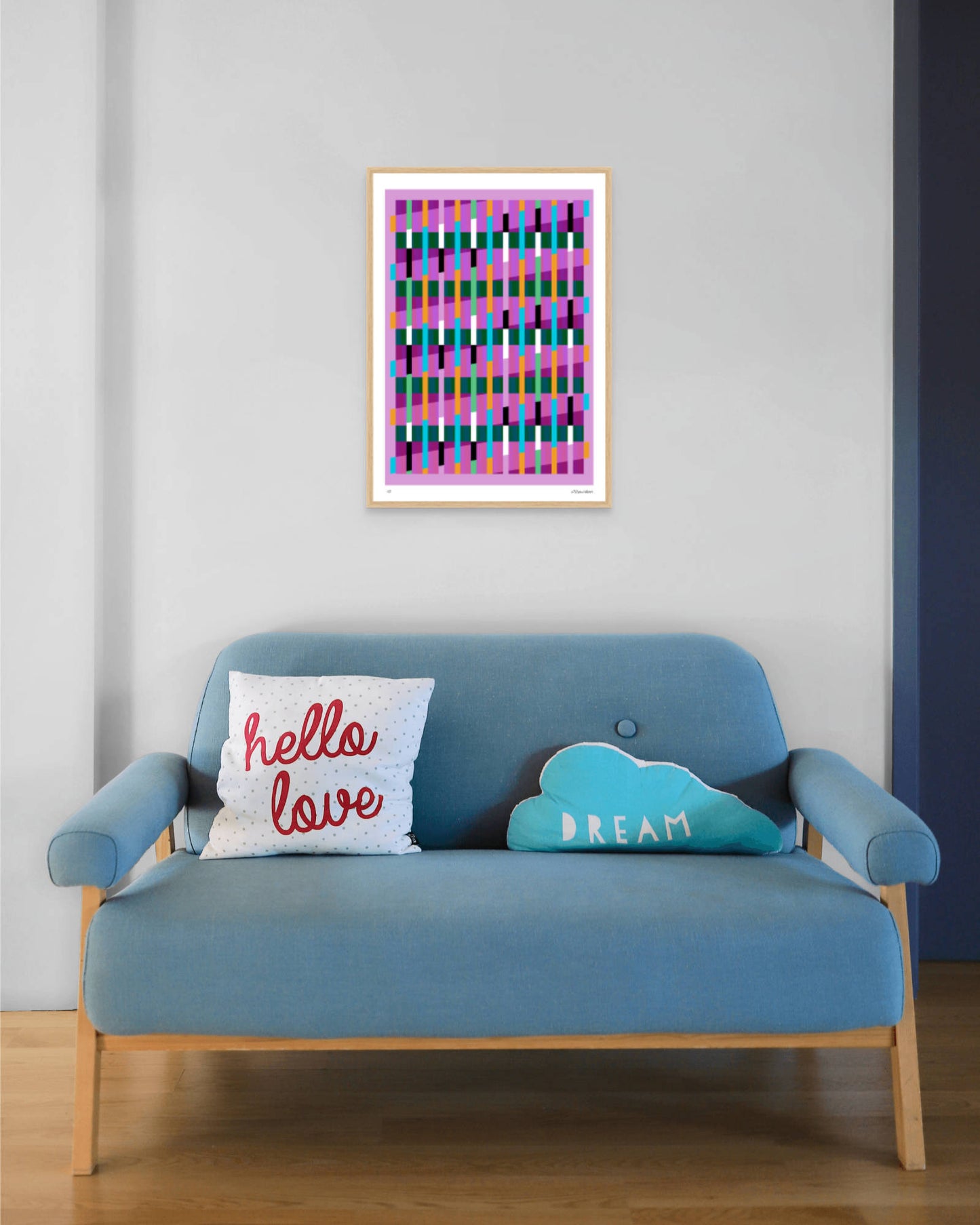 Pink geometric abstract giclée print by Victoria Mardon in an oak frame displayed above a blue mid-century sofa