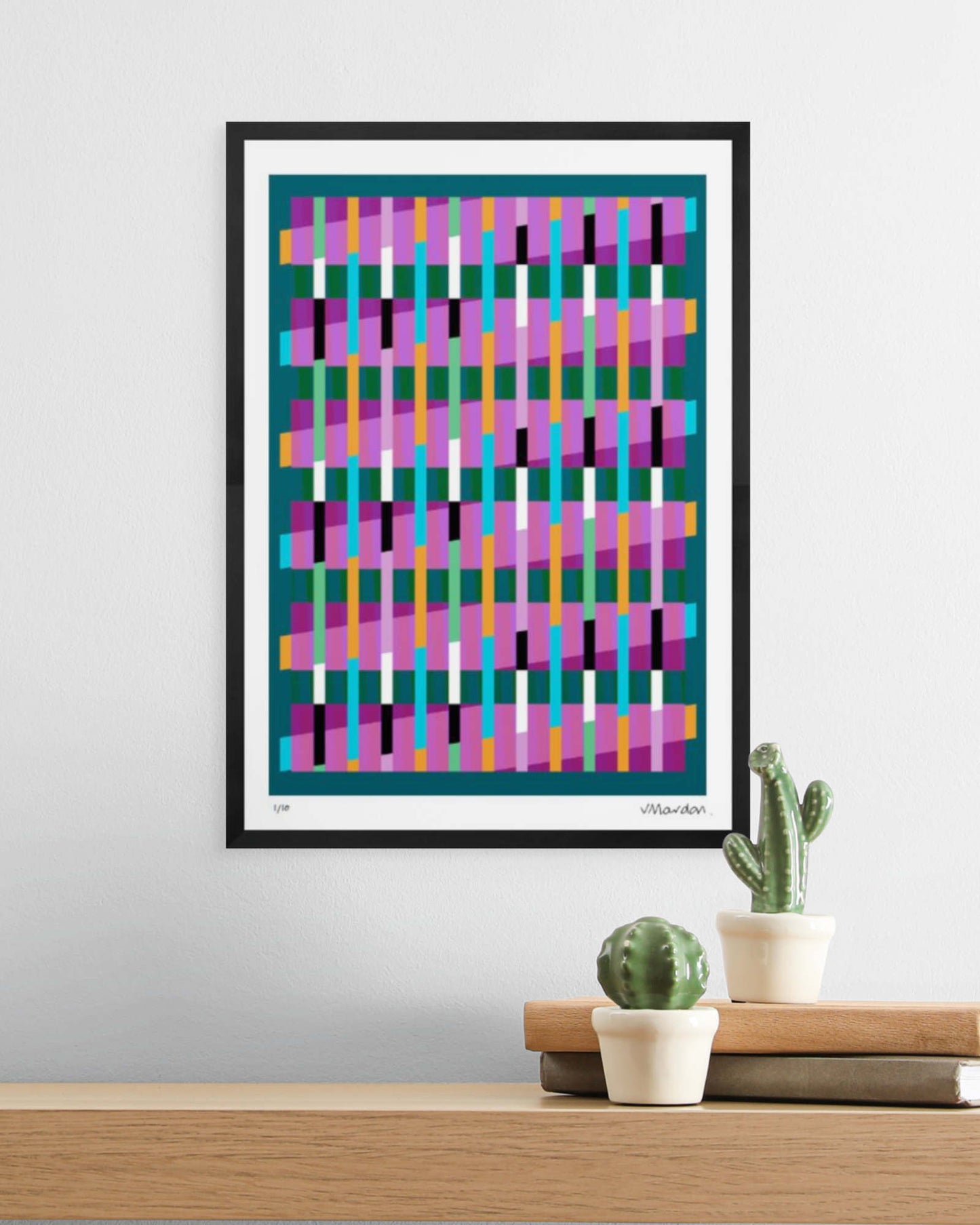 A3 black-framed geometric abstract giclée print by Victoria Mardon displayed on a white wall above an oak shelf