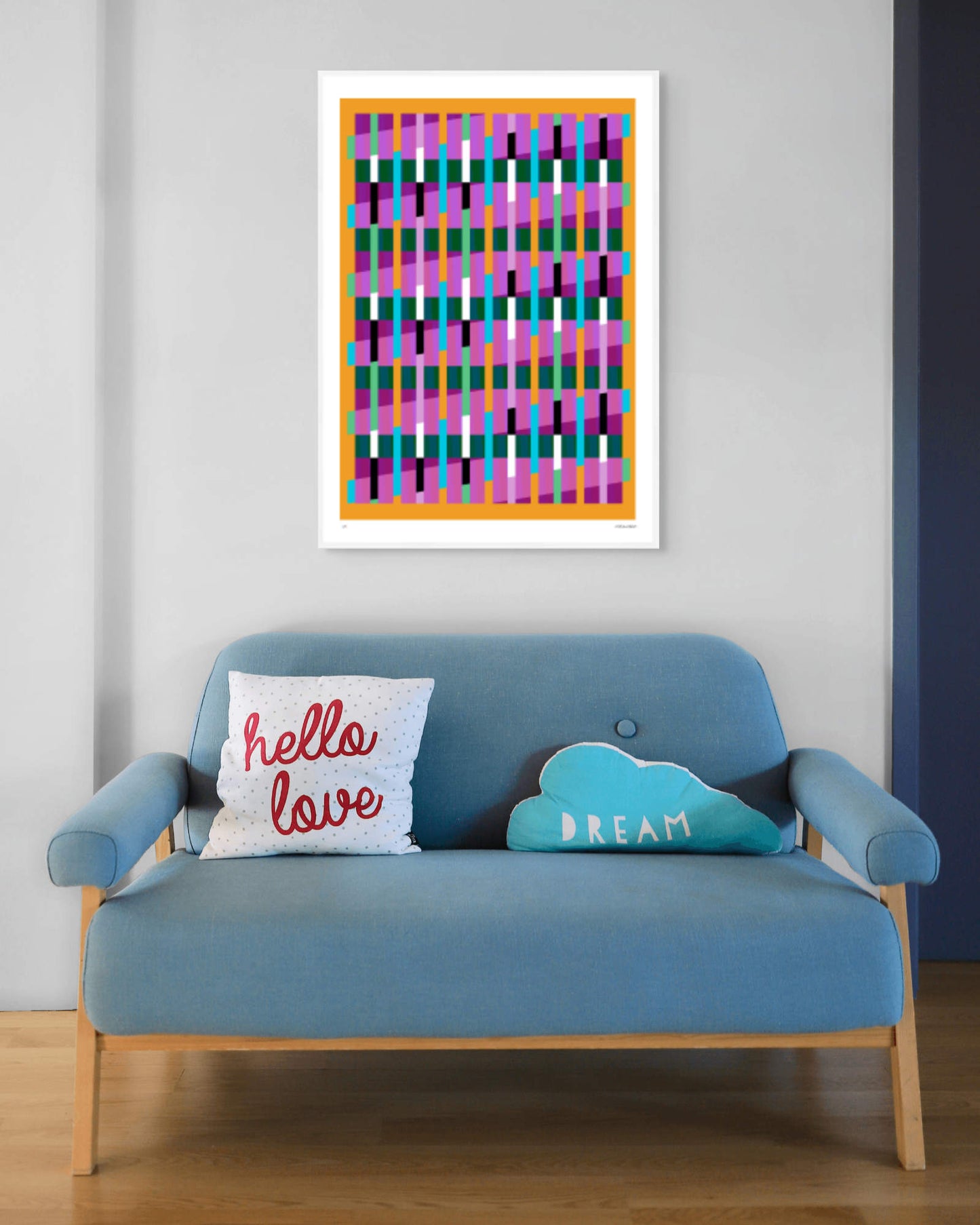 Yellow geometric abstract giclée print by Victoria Mardon in a white frame displayed above a blue mid-century sofa
